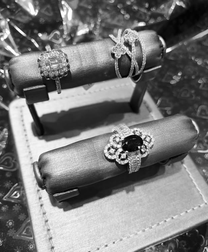 Diamond cluster rings displayed on a padded roll