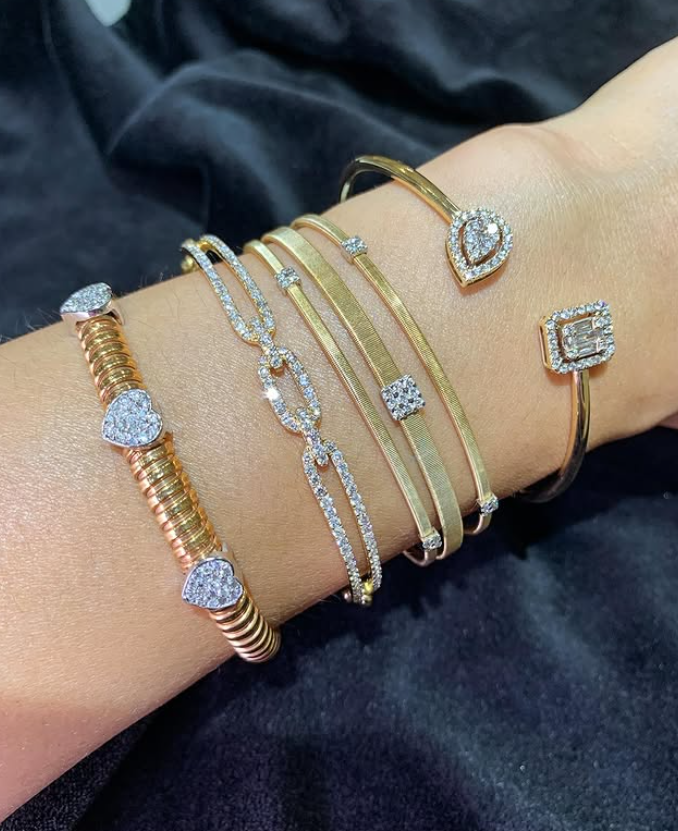 Rose and yellow gold diamond bracelets on the wrist
