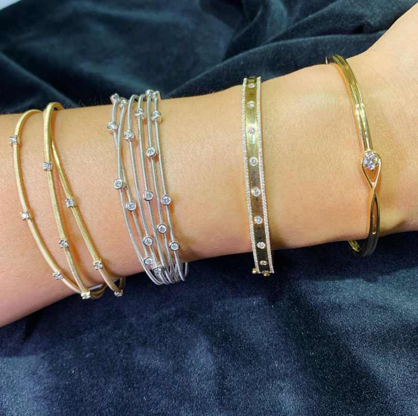 Stacked diamond bangles worn on the wrist